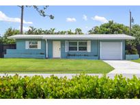 Ranch style home with a carport and a well-maintained lawn at 3064 Pinetree St, Port Charlotte, FL 33952