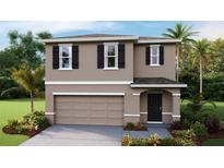 Two-story house with neutral siding, two-car garage, and landscaping at 36055 Sunflower Hill Dr, Zephyrhills, FL 33541