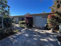 Ranch style home with attached garage and well-manicured landscaping at 6640 Bay St, St Pete Beach, FL 33706