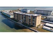 Aerial view of waterfront condo building with parking and water access at 9 Haig Pl # 707, Dunedin, FL 34698