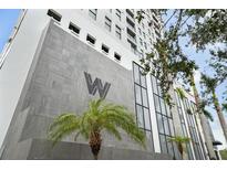 Modern building exterior with gray stone and palm trees at 226 5Th N Ave # 1106, St Petersburg, FL 33701
