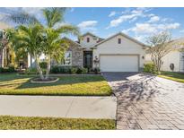 Beautiful one-story home with stone accents and a large driveway at 3409 77Th E Ct, Palmetto, FL 34221