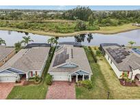 Stunning aerial view of a home, showing its solar panels, waterside location, and neighboring houses at 6028 Milestone Dr, Apollo Beach, FL 33572
