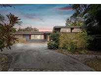 Ranch style home with circular driveway and mature landscaping at 1824 Southwood Ln, Clearwater, FL 33764