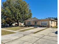 Ranch style home with mature landscaping and a spacious driveway at 4825 Sierra Madre Dr, Tampa, FL 33634