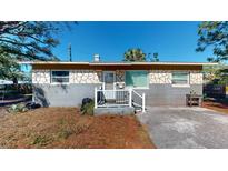 House exterior with stone and grey siding at 827 26Th S Ave, St Petersburg, FL 33705