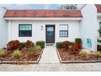 Inviting condo exterior featuring a well-manicured landscape and a charming entrance at 9224 Mission Oaks Blvd, Seminole, FL 33776