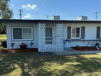 Charming single-story home with decorative white privacy screen and well-maintained front yard at 1002 N Pebble Beach Blvd # 1002, Sun City Center, FL 33573
