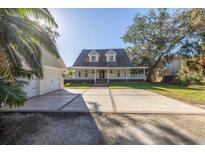 Two-story house with a large front porch and attached garage at 7172 Dr Martin Luther King Jr S St, St Petersburg, FL 33705