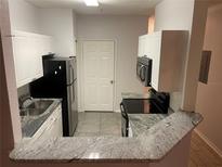 Modern kitchen with granite countertops and stainless steel appliances at 18001 Richmond Place Dr # 125, Tampa, FL 33647