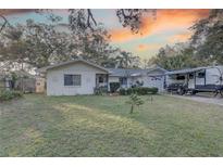 House exterior featuring a spacious yard and RV parking at 4918 Woodland Dr, St Petersburg, FL 33708