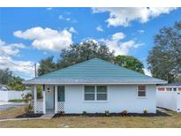Newly renovated single story home with teal roof and white exterior at 5718 Magnolia N St, St Petersburg, FL 33703