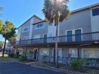 Two-story condo building with balconies and lush landscaping at 6301 Newtown Cir # 1B1, Tampa, FL 33615