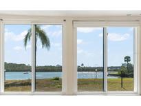 Spacious windows offer stunning views of the water and bridge at 1 Windrush Blvd # 15, Indian Rocks Beach, FL 33785