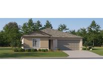 One-story home with beige siding, gray roof, and a two-car garage at 10143 Gentle Rain Dr, Land O Lakes, FL 34638