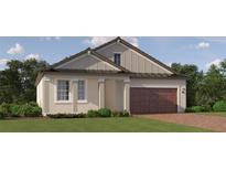 One-story home with a brown door and brick driveway at 9650 Minnow Ray Dr, Land O Lakes, FL 34638