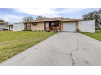 Tan one-story house with a white garage door and landscaped lawn at 3411 28Th E St, Bradenton, FL 34208