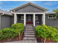 Gray house with a white door and large front porch at 930 Monterey Ne Pt, St Petersburg, FL 33704