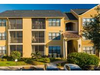 Two-story condo building with yellow exterior and ample parking at 11901 4Th N St # 9105, St Petersburg, FL 33716