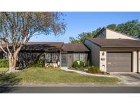 Attractive exterior of a condo with a well-maintained lawn and a two-car garage at 2101 Sunset Point Rd # 1102, Clearwater, FL 33765