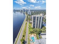 Aerial view of waterfront highrise building with pool and lush landscaping at 2413 Bayshore Blvd # 404, Tampa, FL 33629