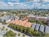 Aerial view of a community near the city with various building styles and a Publix supermarket nearby at 410 S Armenia Ave # 926, Tampa, FL 33609