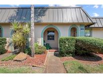 Inviting condo with a charming front porch and well-manicured landscaping at 4366 Summersun Dr, New Port Richey, FL 34652