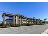 Low-rise condo building with palm trees and landscaping at 4455 Duhme Rd # 304, St Petersburg, FL 33708