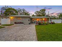 Charming single-story home with stone facade, paver driveway, and landscaped yard at 7301 2Nd S Ave, St Petersburg, FL 33707