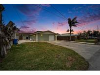 Inviting single-story home with a two-car garage and well-manicured lawn at 1022 Canal St, Ruskin, FL 33570