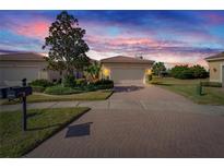 Attractive single-story home with a two-car garage and landscaped front yard at 15618 Aurora Lake Cir, Wimauma, FL 33598