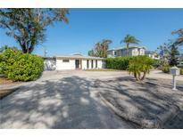 Single-story home with a front yard, driveway and neighboring houses visible at 3611 W De Leon St, Tampa, FL 33609
