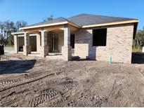 Brick house under construction, featuring a covered porch and large windows at 422 Shannon Estates Ct, Plant City, FL 33563
