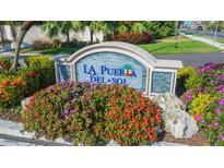 La Puerta Del Sol community entrance with landscaping at 5633 Puerta Del Sol S Blvd # 203, St Petersburg, FL 33715