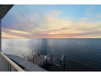 Stunning sunset over calm water; private dock with boat lift at 6423 Driftwood Dr, Hudson, FL 34667