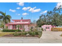 Pink house with a long driveway and guest house at 700 S Prospect Ave, Clearwater, FL 33756