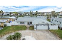 Single story home with a two car garage and landscaped yard at 11185 5Th E St, Treasure Island, FL 33706