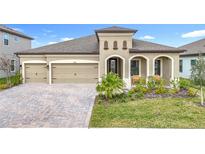 Two-story home with attractive landscaping and a two-car garage at 13028 Homestead Ln, Parrish, FL 34219