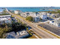 Aerial view of waterfront community with buildings and parking at 131 Bluff View Dr # 103, Belleair Bluffs, FL 33770