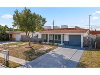 Inviting single story home featuring a landscaped yard and attached garage at 3421 Cantrell St, Holiday, FL 34690