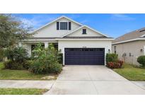 Single-story house with a two-car garage and landscaped front yard at 5725 Stockport St, Riverview, FL 33578