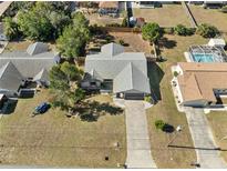 Aerial view of a single-story house with a pool and large backyard at 2139 Abby Ave, Spring Hill, FL 34609