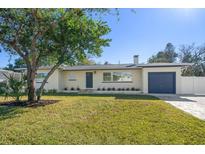 Newly renovated home with a landscaped lawn and modern facade at 7516 38Th N Ave, St Petersburg, FL 33710