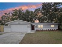 Charming single story home with gray exterior and two-car garage at 11592 110Th Ter, Seminole, FL 33778