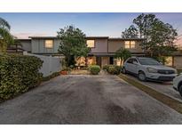 Two-story townhome with a paved driveway and well-manicured landscaping at 14105 Village View Dr, Tampa, FL 33624