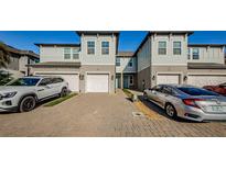 Two-story townhome with white garage doors and light gray siding at 1621 Eagle Creek Dr, Clearwater, FL 33764