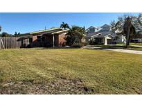 Brick ranch home with a spacious lawn and fenced yard at 4401 Helena Ne St, St Petersburg, FL 33703