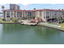 Aerial view of condo building, pool, and marina at 105 Island Way # 146, Clearwater, FL 33767