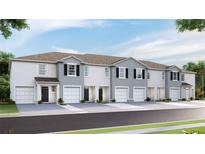 Modern townhouses with two-car garages and neutral color palettes at 32599 Turtle Grace Loop, Wesley Chapel, FL 33545