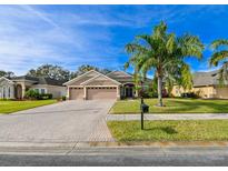 Beautiful two-story home with a three-car garage and a nicely landscaped lawn at 3407 Walden Reserve Dr, Plant City, FL 33566